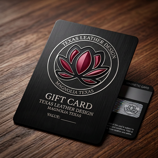 Black Texas Leather Design gift card with burgundy magnolia logo on a wooden surface