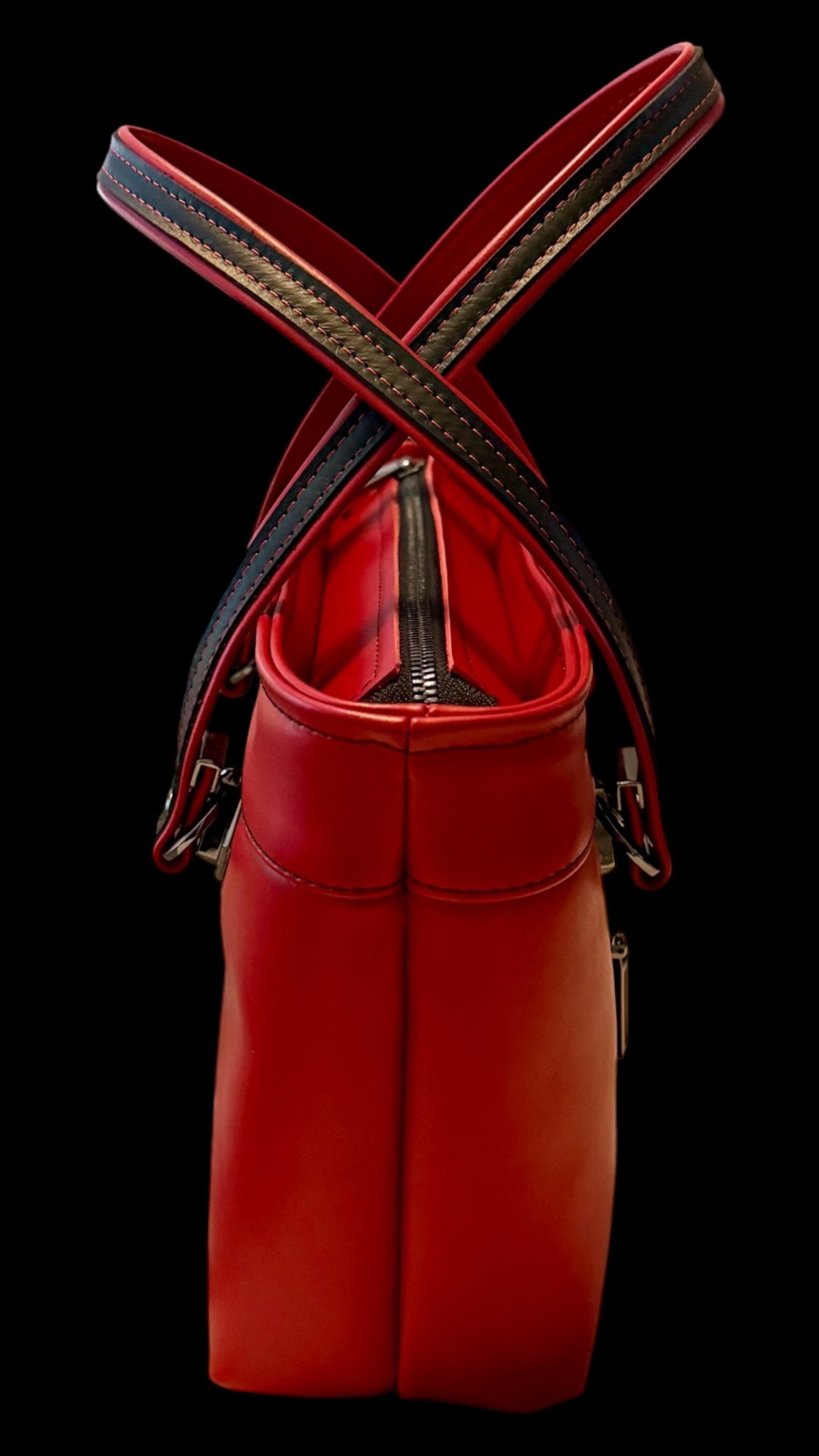 Black zipper tape installed in the top opening of a red leather bag